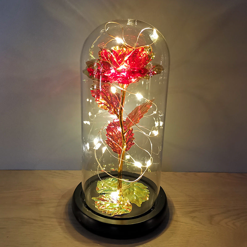 La rose en or sous couverture en verre avec éclairage Led